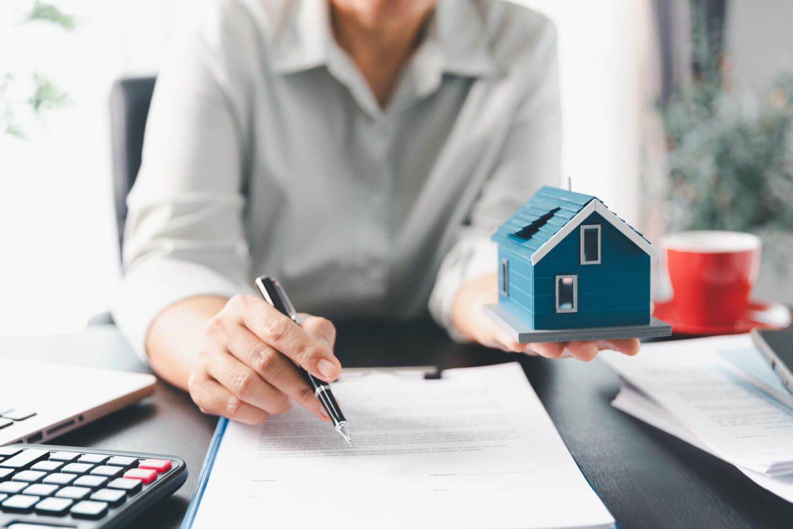 Real estate agent agree to buy home to clients agency office. House model, real estate agent, customer discussing for contract to buy house, insurance, loan real estate background. Concept agreement.